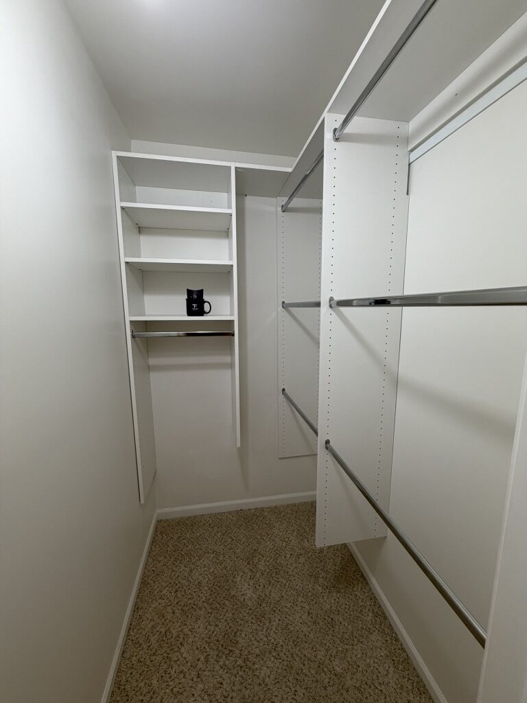 Custom walk-in closet by TrueForm Closets