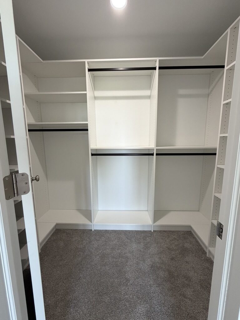 Custom walk-in closet by TrueForm Closets