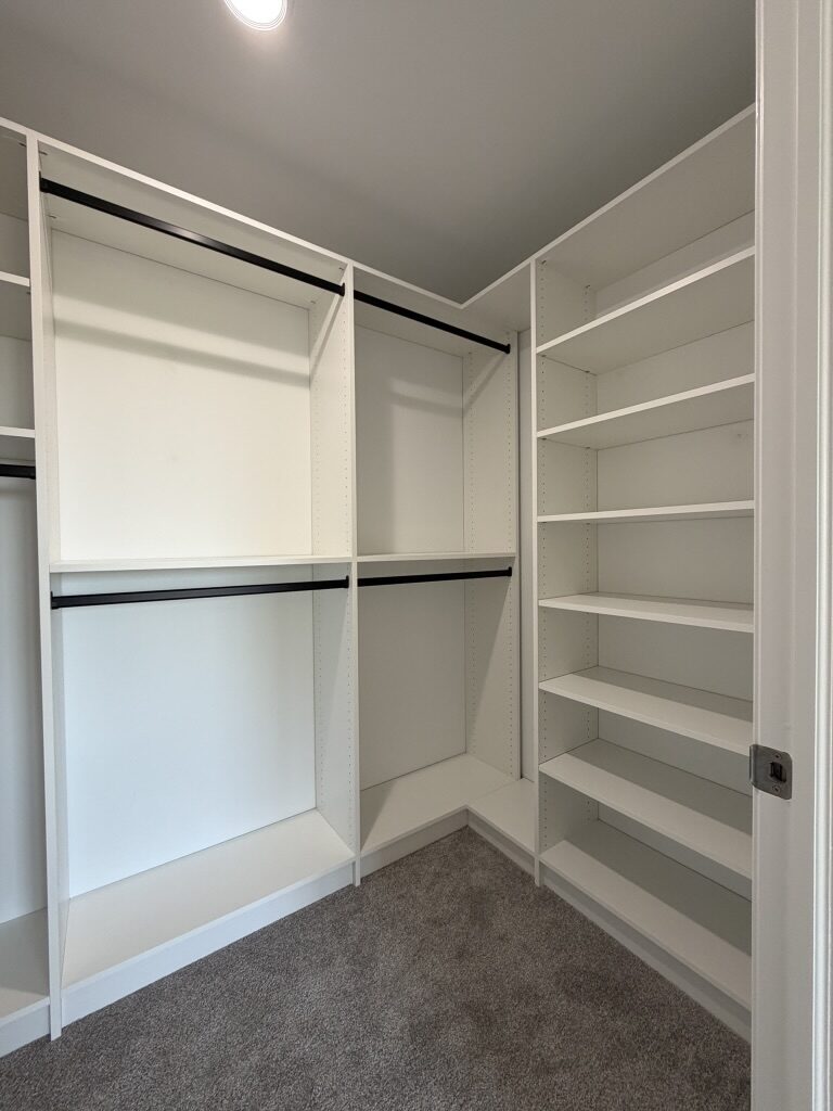 Custom walk-in closet by TrueForm Closets