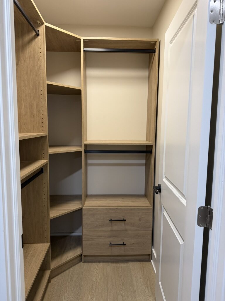 Custom walk-in closet by TrueForm Closets