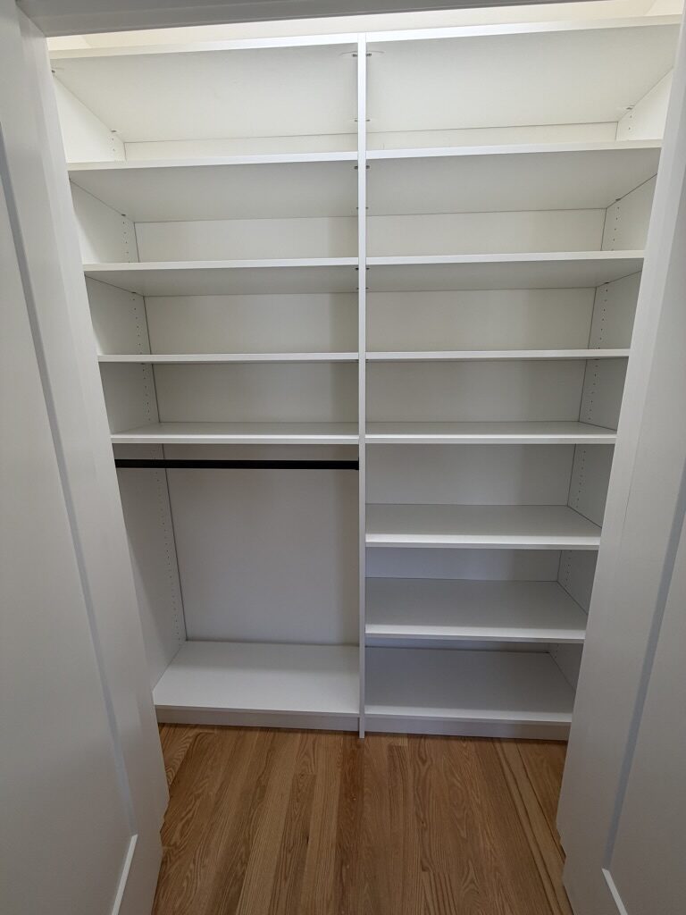 Custom reach-in closet by TrueForm Closets