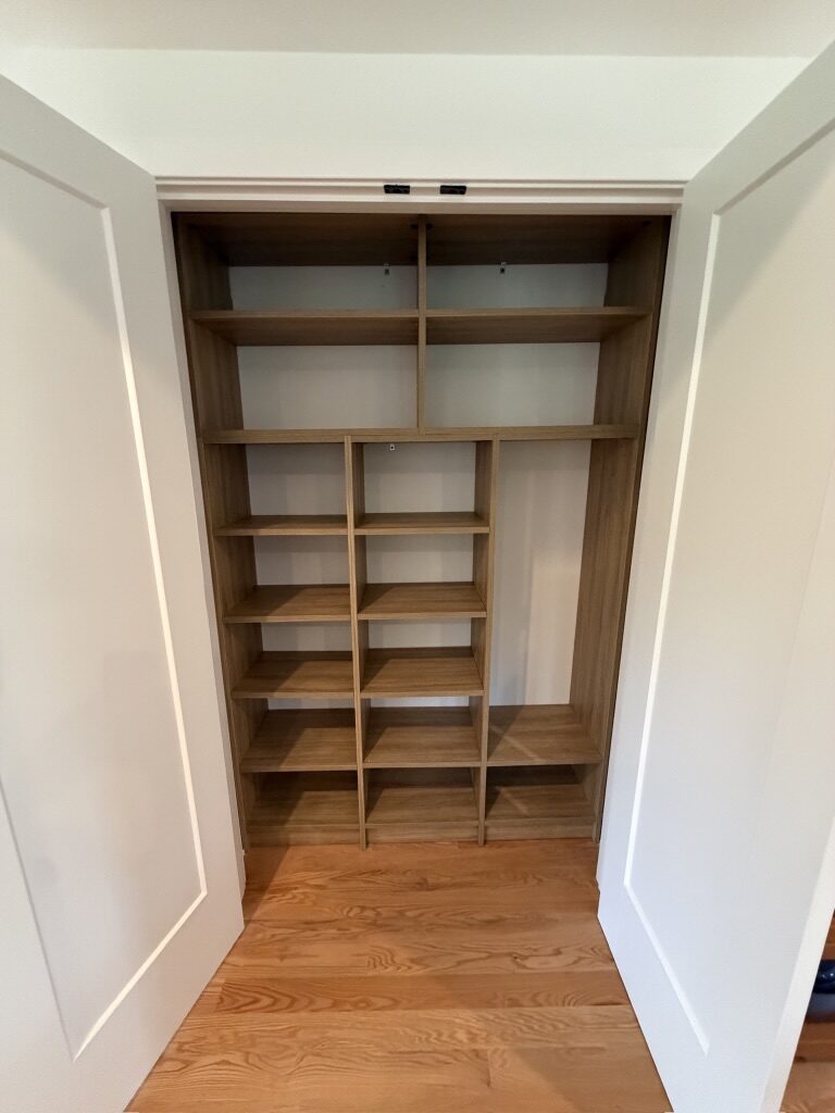 Custom reach-in closet by TrueForm Closets