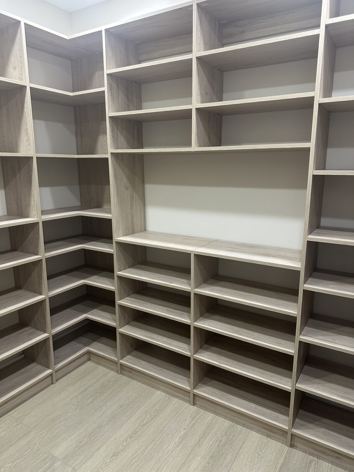 Custom walk-in closet by TrueForm Closets