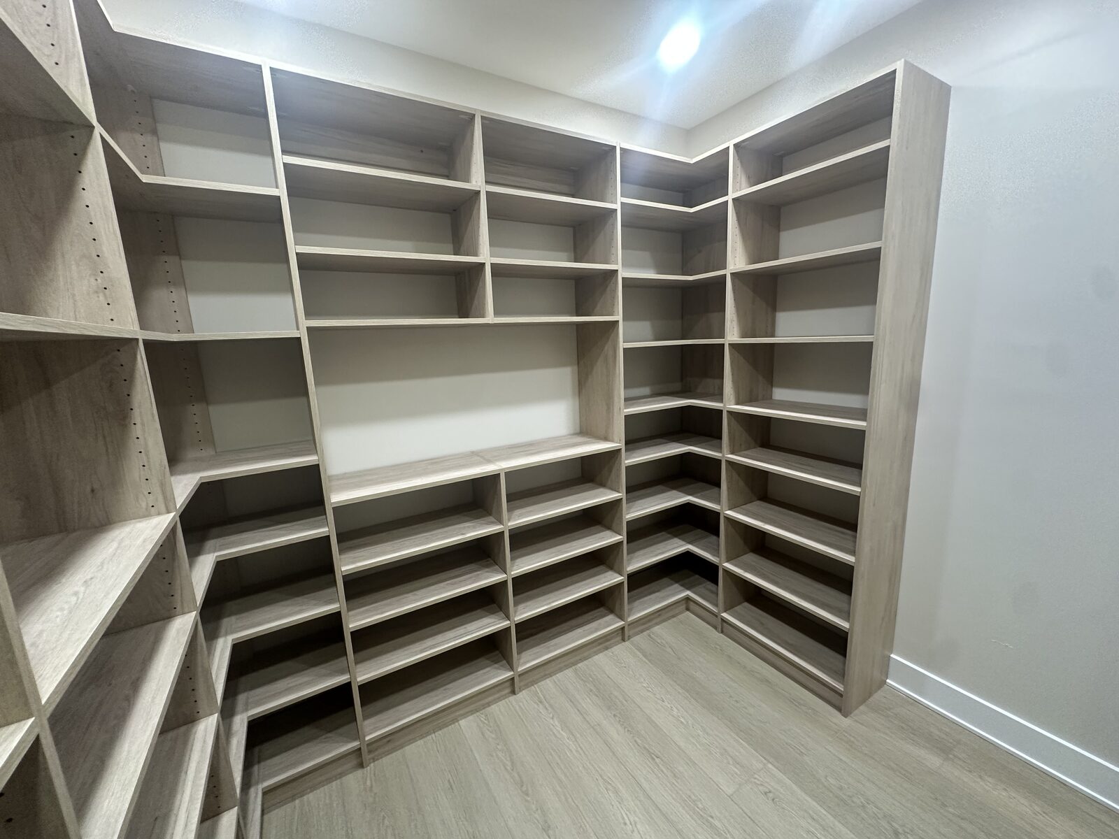 Custom walk-in closet by TrueForm Closets