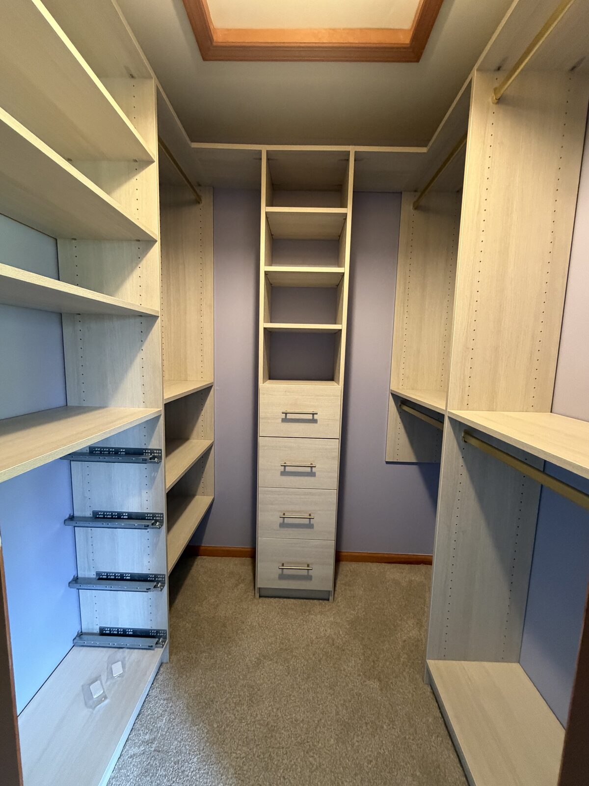Custom walk-in closet by TrueForm Closets